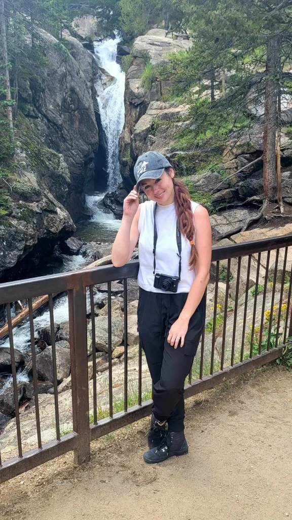 a girl who walks beside the falls and big rocks