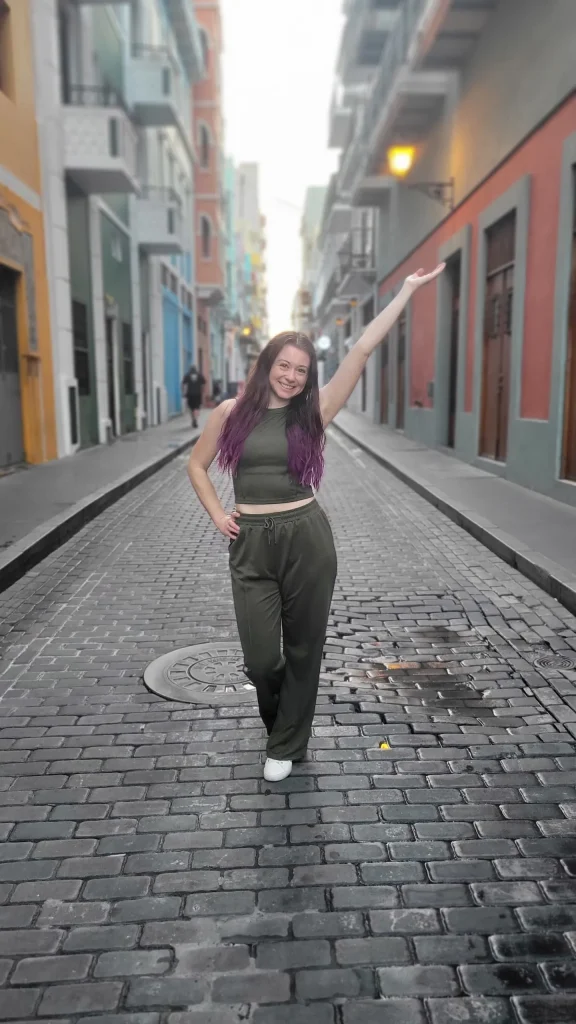 a girl who walks in the street beside the buildings